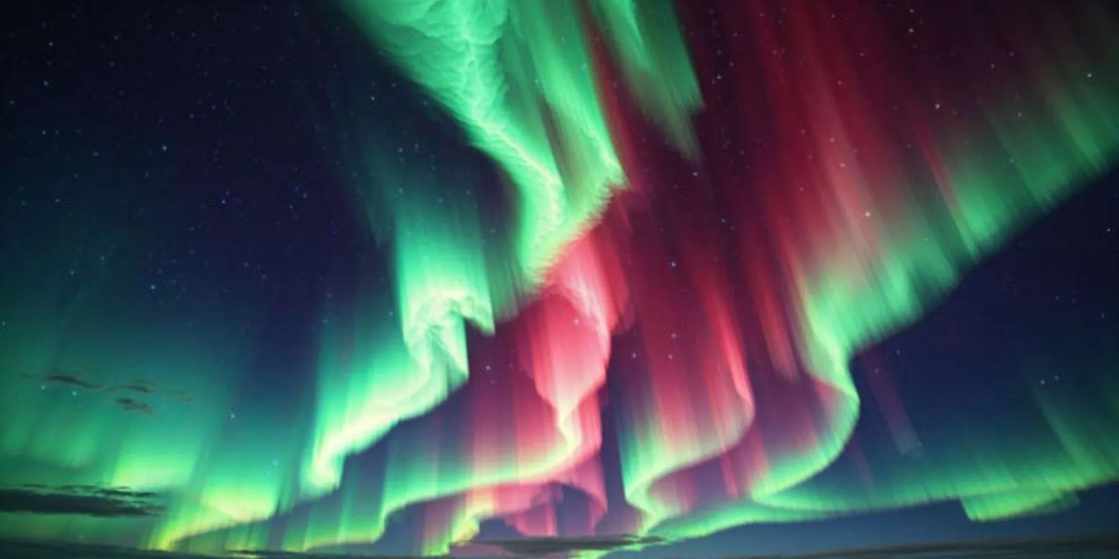 Dramatic green and red aurora curtains filling the night sky over the Alaska interior